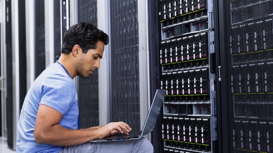 Man in front of server board.