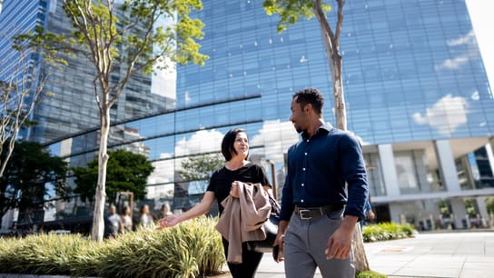 Coworkers talking while walking in the street