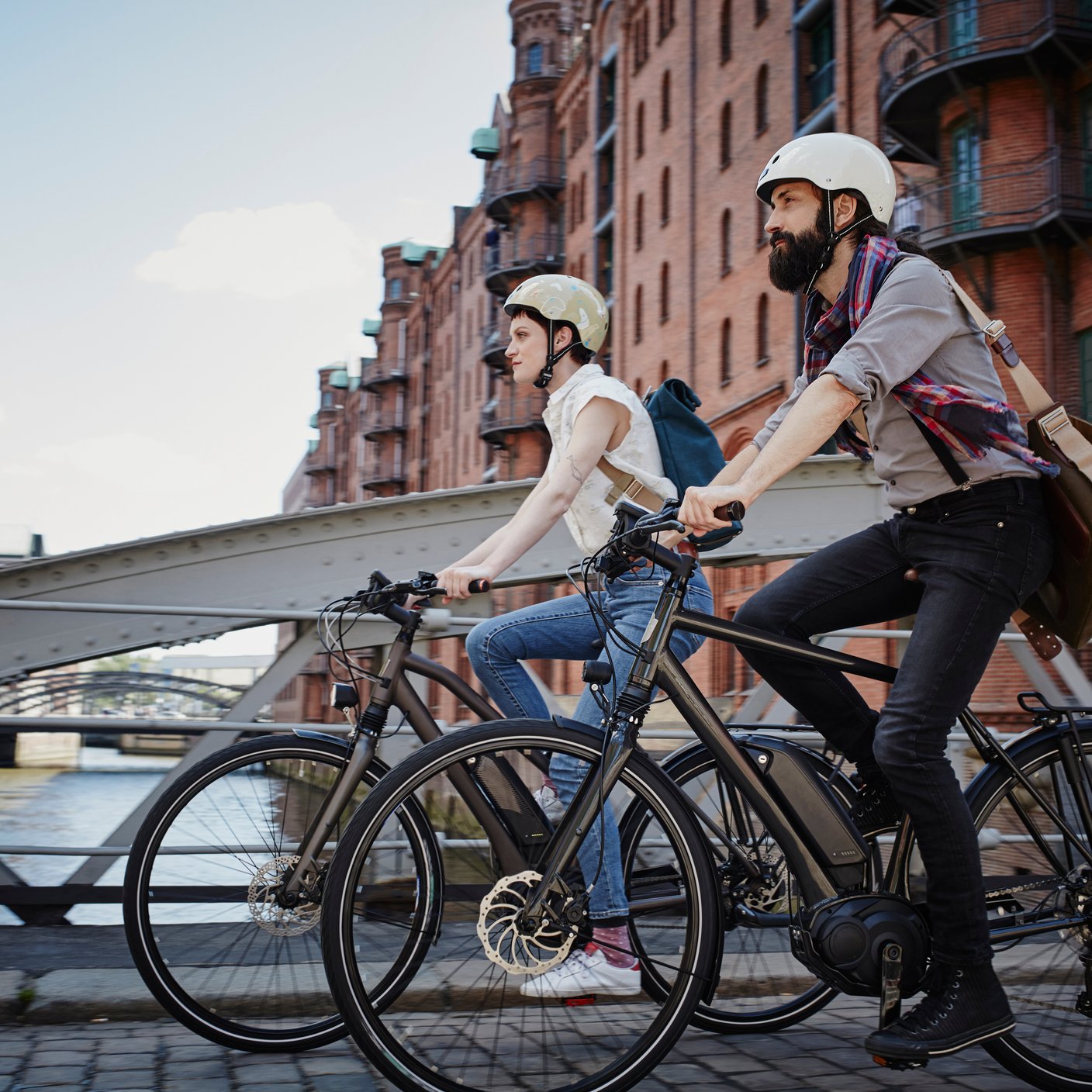 One female and one male ride bicycle