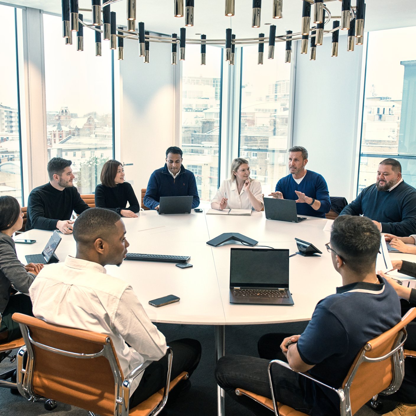 A group of people around table in office.