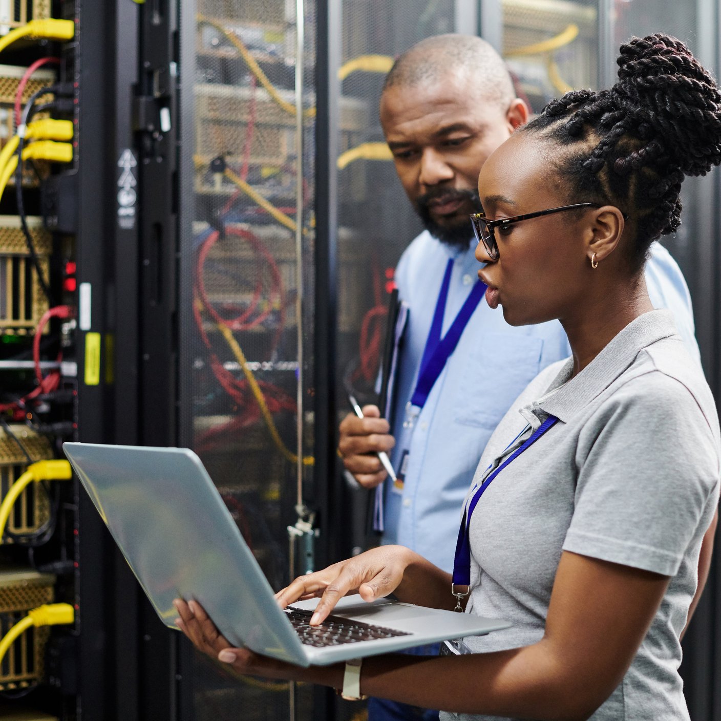 IT professionals managing server room network systems