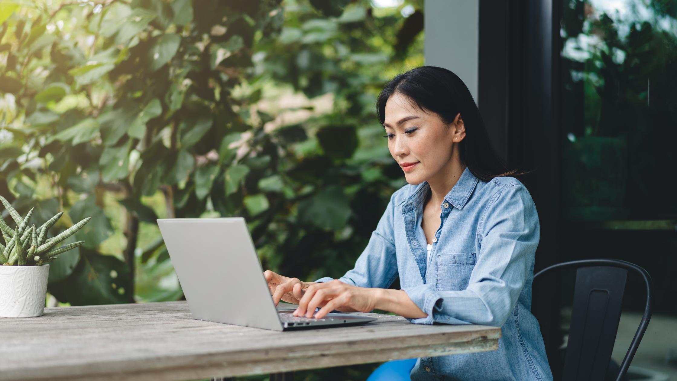 lady works on her laptop outdoors